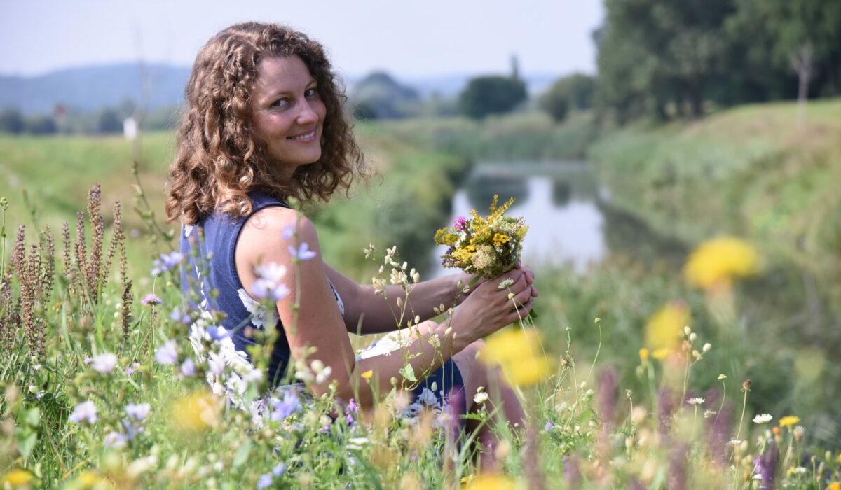 Elisabeth Teufner, Gründerin der wild.wuchs.Natur - Akademie in einer Blumenwiese
